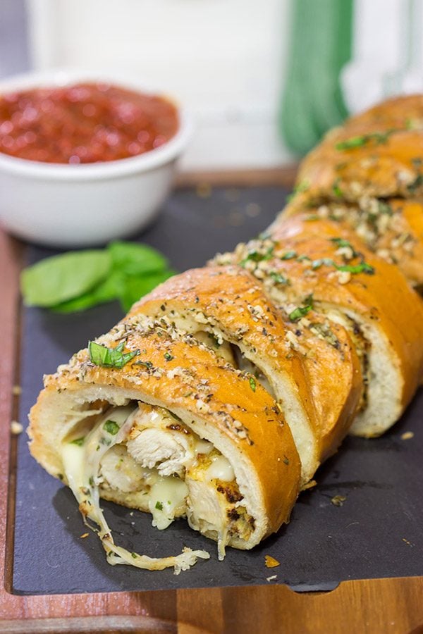 This Chicken Parm Stuffed Garlic Bread is 2 comfort food favorites in 1! Crispy chicken and melty cheese stuffed inside garlicky, buttery bread. Pass me a slice!