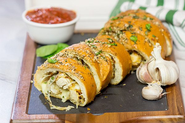 This Chicken Parm Stuffed Garlic Bread is 2 comfort food favorites in 1!  Crispy chicken and melty cheese stuffed inside garlicky, buttery bread.  Pass me a slice!