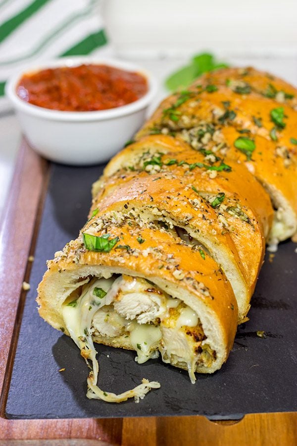 This Chicken Parm Stuffed Garlic Bread is 2 comfort food favorites in 1!  Crispy chicken and melty cheese stuffed inside garlicky, buttery bread.  Pass me a slice!