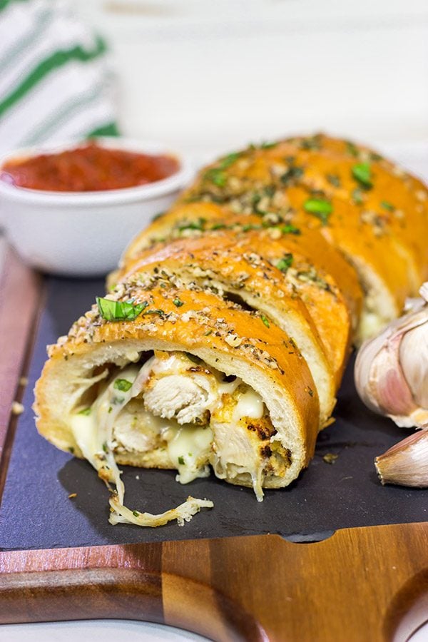 This Chicken Parm Stuffed Garlic Bread is 2 comfort food favorites in 1! Crispy chicken and melty cheese stuffed inside garlicky, buttery bread. Pass me a slice!