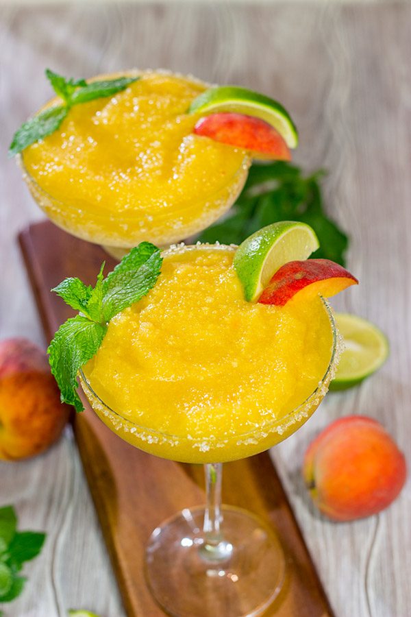Grab the margarita glasses and celebrate warm summer evenings with a pitcher of these Peach Margaritas!  Cheers!