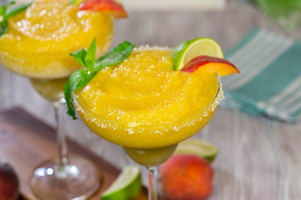 Grab the margarita glasses and celebrate warm summer evenings with a pitcher of these Peach Margaritas!  Cheers!