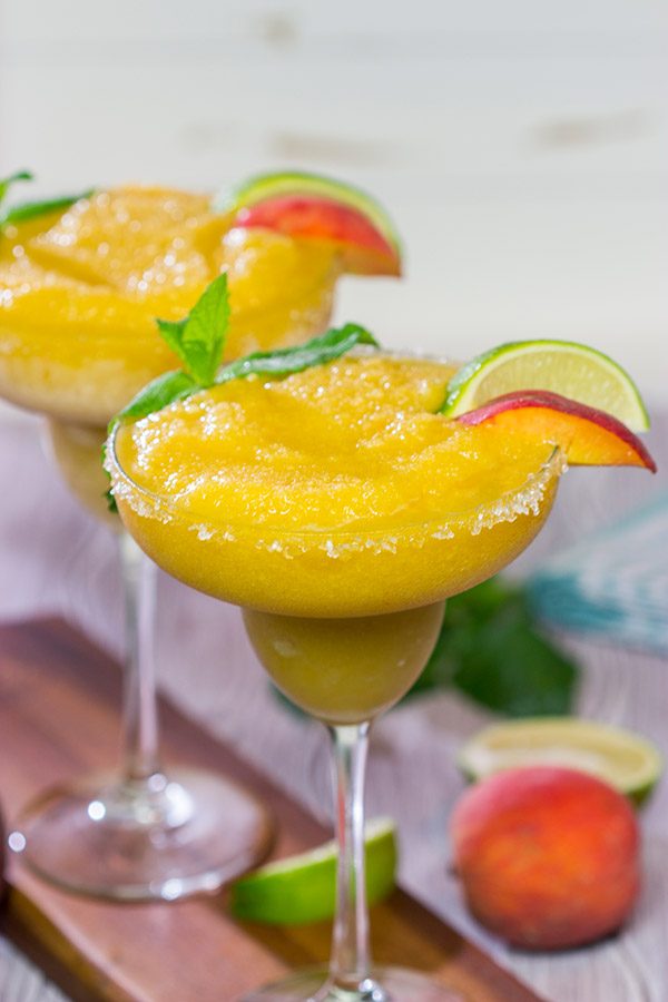 Grab the margarita glasses and celebrate warm summer evenings with a pitcher of these Peach Margaritas!  Cheers!