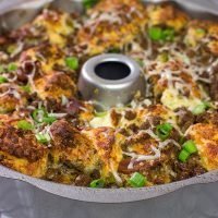 Packed with seasoned ground beef, bacon and two types of cheese, this Bacon Cheeseburger Monkey Bread makes for one heck of a delicious gameday appetizer!