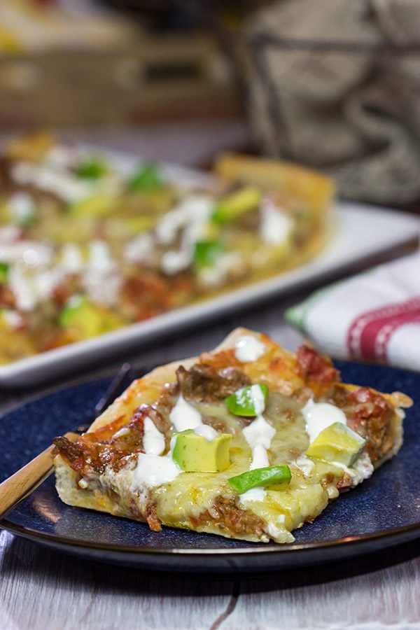 Make tonight a taco...err, pizza...night!  This Deep Dish Taco Pizza is a fun way to enjoy your favorite taco toppings in pizza form!
