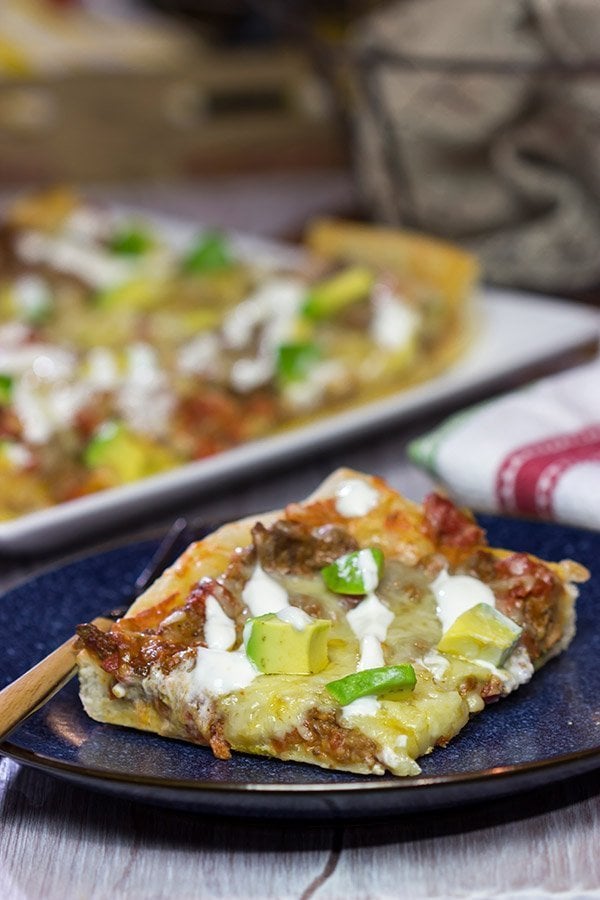 Make tonight a taco...err, pizza...night!  This Deep Dish Taco Pizza is a fun way to enjoy your favorite taco toppings in pizza form!
