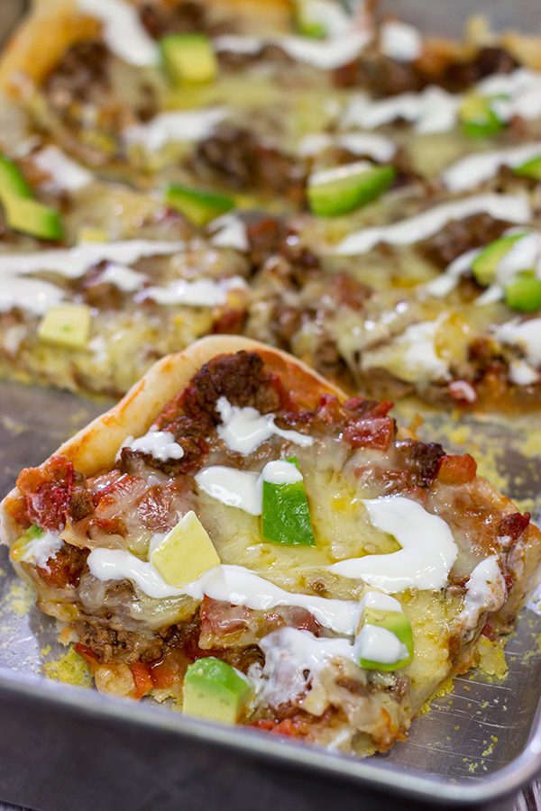 Make tonight a taco...err, pizza...night!  This Deep Dish Taco Pizza is a fun way to enjoy your favorite taco toppings in pizza form!