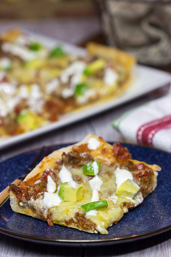Make tonight a taco...err, pizza...night!  This Deep Dish Taco Pizza is a fun way to enjoy your favorite taco toppings in pizza form!