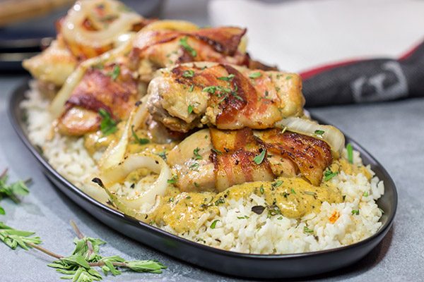 These Bacon-Wrapped Chicken Thighs are served over seasoned rice with a Dijon cream sauce. Sounds fancy, right? But this recipe came out of your own kitchen!