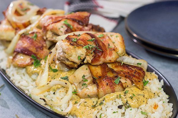These Bacon-Wrapped Chicken Thighs are served over seasoned rice with a Dijon cream sauce. Sounds fancy, right? But this recipe came out of your own kitchen!