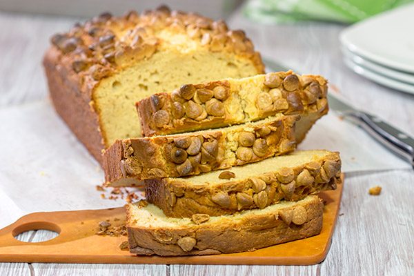 Topped with peanut butter baking chips, this Peanut Butter Bread is a moist cake-like quick bread that's perfect for snacking or dessert!