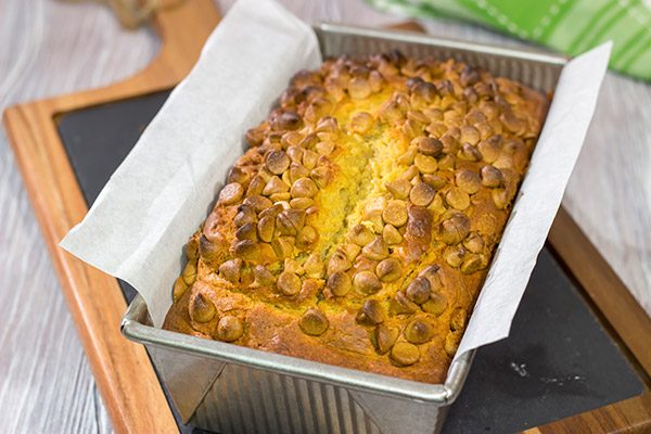 Topped with peanut butter baking chips, this Peanut Butter Bread is a moist cake-like quick bread that's perfect for snacking or dessert!