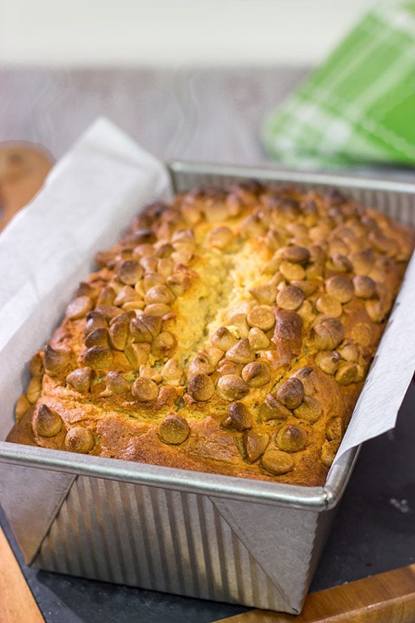 Topped with peanut butter baking chips, this Peanut Butter Bread is a moist cake-like quick bread that's perfect for snacking or dessert!