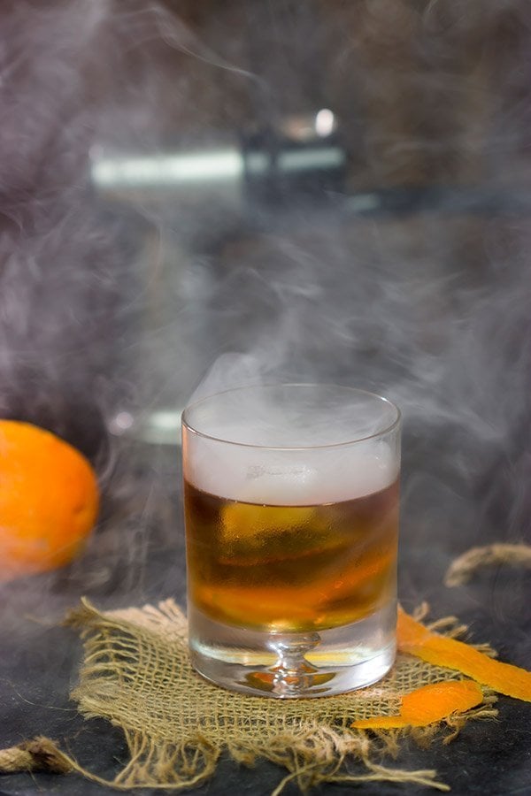 This Smoked Old Fashioned introduces maple syrup and smoke for a fun twist on a classic cocktail!