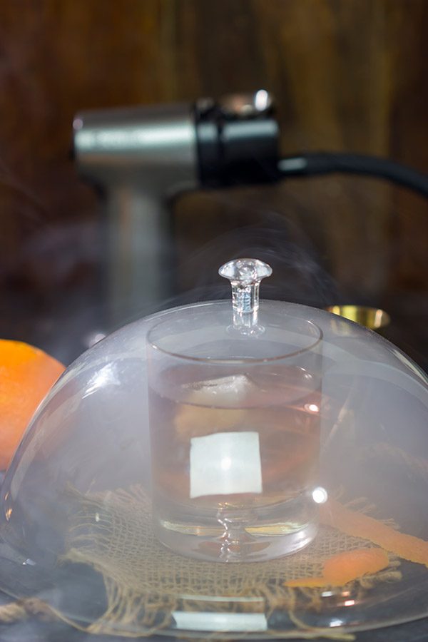 This Smoked Old Fashioned introduces maple syrup and smoke for a fun twist on a classic cocktail!