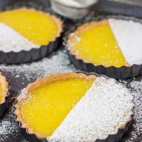 These Lemon Tarts feature a creamy lemon filling inside a crispy sugar cookie crust! Talk about one heck of a delicious dessert!