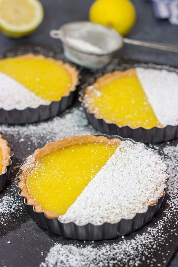 These Lemon Tarts feature a creamy lemon filling inside a crispy sugar cookie crust!  Talk about one heck of a delicious dessert!