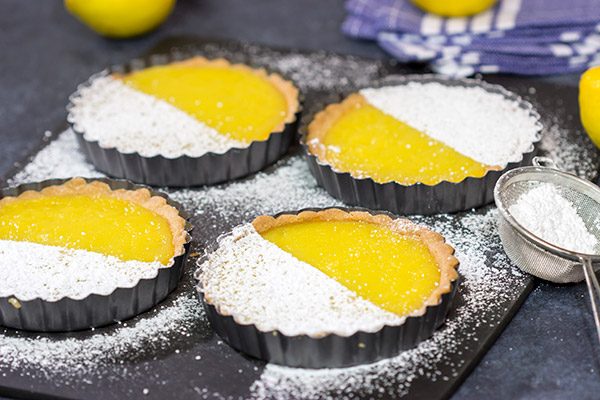 These Lemon Tarts feature a creamy lemon filling inside a crispy sugar cookie crust! Talk about one heck of a delicious dessert!