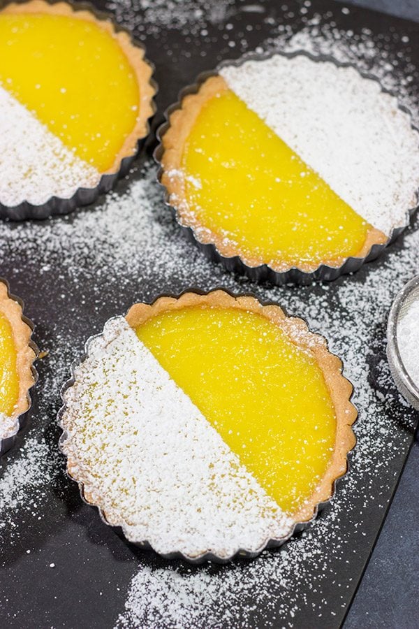These Lemon Tarts feature a creamy lemon filling inside a crispy sugar cookie crust! Talk about one heck of a delicious dessert!