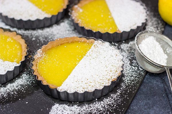 These Lemon Tarts feature a creamy lemon filling inside a crispy sugar cookie crust! Talk about one heck of a delicious dessert!