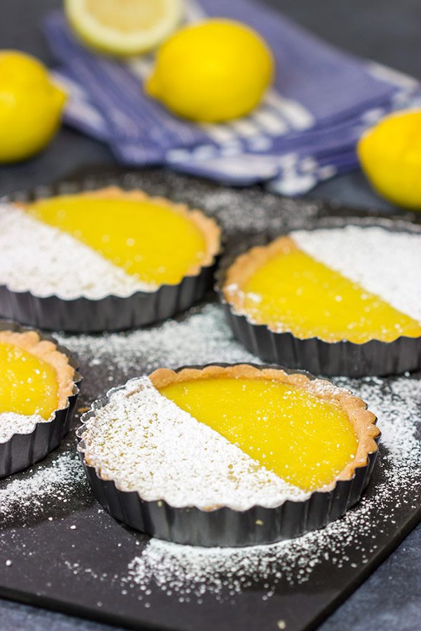 These Lemon Tarts feature a creamy lemon filling inside a crispy sugar cookie crust! Talk about one heck of a delicious dessert!