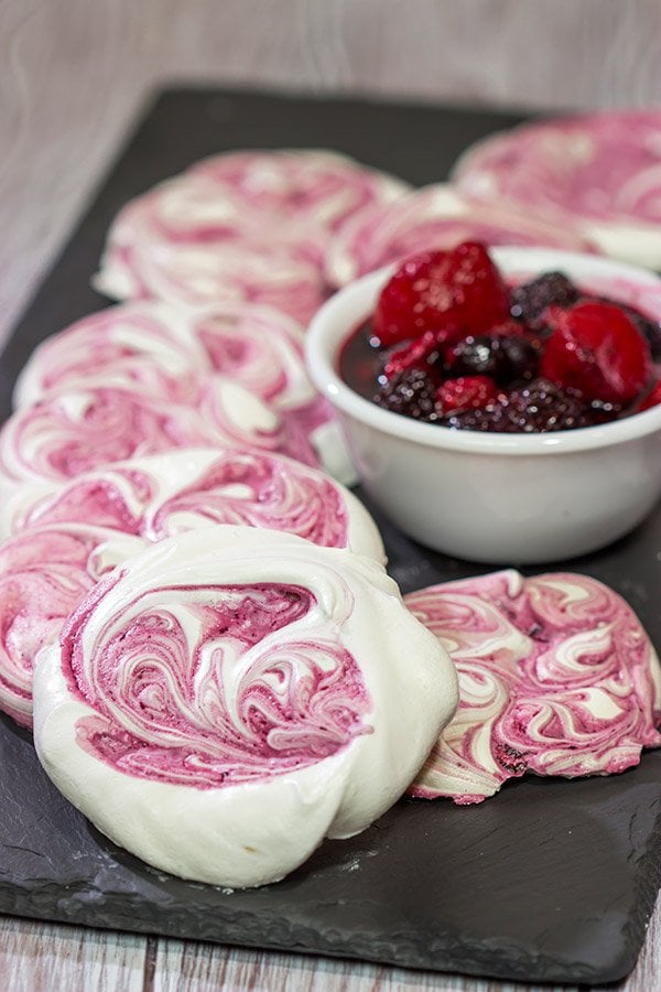 These Blackberry Meringues with Mixed Berry Compote are a light, airy dessert that's perfect for summer picnics!
