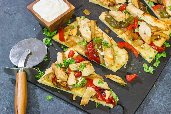 Looking for an easy and delicious dinner for game night? These Chicken Fajita Flatbreads are sure to be a family favorite!