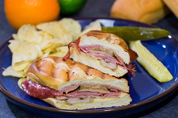 Packed with 3 types of meat, cheese and pickles, these Grilled Cuban Sandwiches are a delicious way to mix up dinner on the grill!