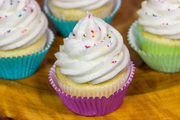 These Vanilla Cupcakes with Vanilla Bean Frosting are a classic!  The cupcakes are soft and fluffy, and the frosting is insanely delicious.  Bake up a batch today!