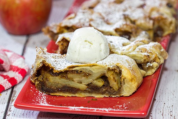 This classic Apple Strudel features crispy pastry dough filled with cinnamon, apples and rum-soaked raisins.  It's a delicious way to celebrate apple season!