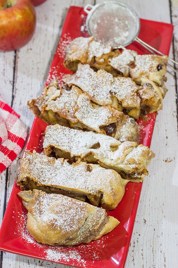 This classic Apple Strudel features crispy pastry dough filled with cinnamon, apples and rum-soaked raisins.  It's a delicious way to celebrate apple season!