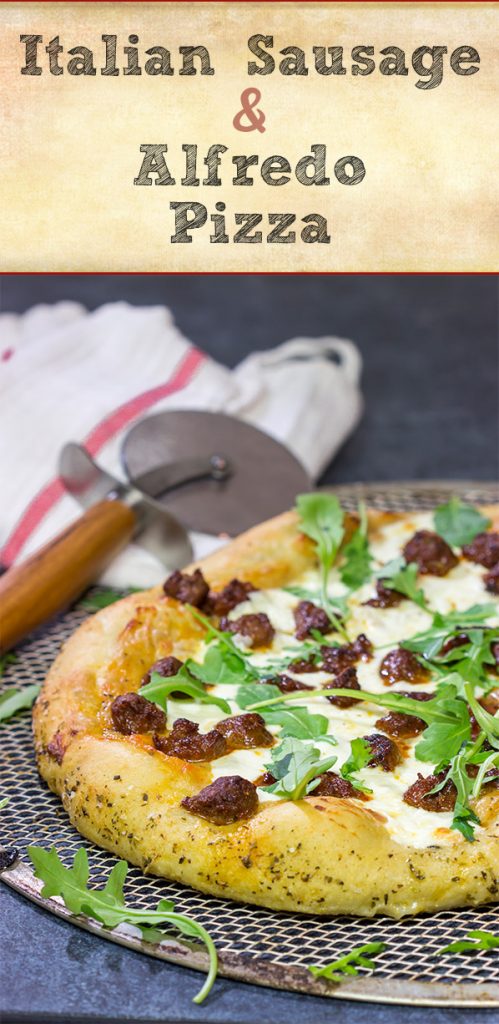 Mix up pizza night! This Italian Sausage and Alfredo Pizza features a delicious alfredo sauce base topped with juicy Italian sausage and fresh arugula!