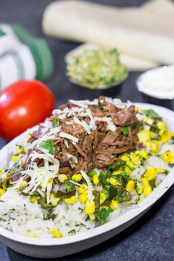 Craving some delicious comfort food?  Then put these Slow Cooker Beef Barbacoa Burrito Bowls on the menu!