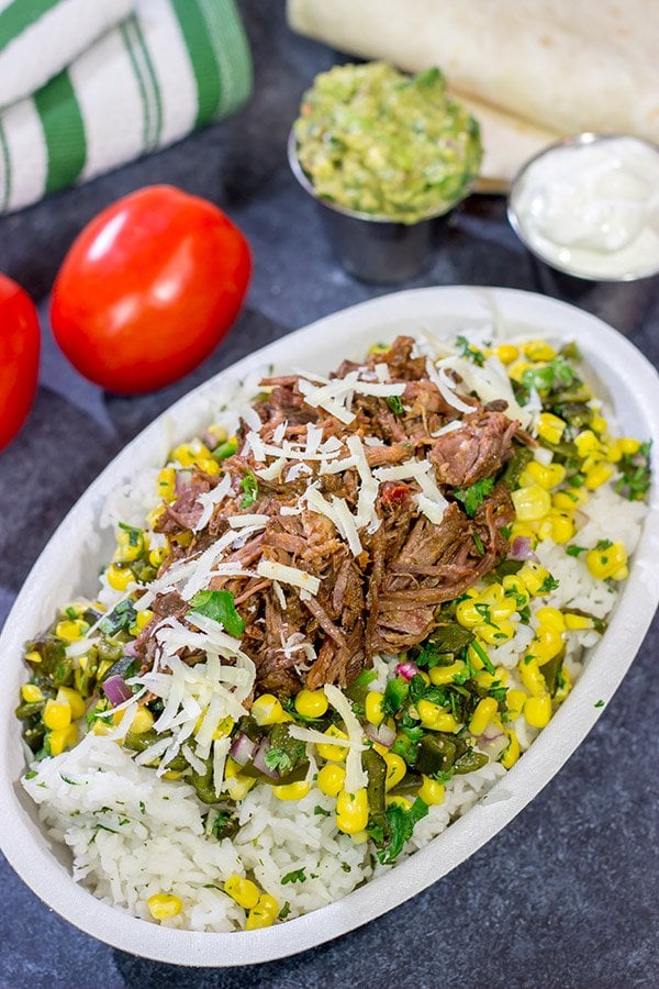 Craving some delicious comfort food?  Then put these Slow Cooker Beef Barbacoa Burrito Bowls on the menu!