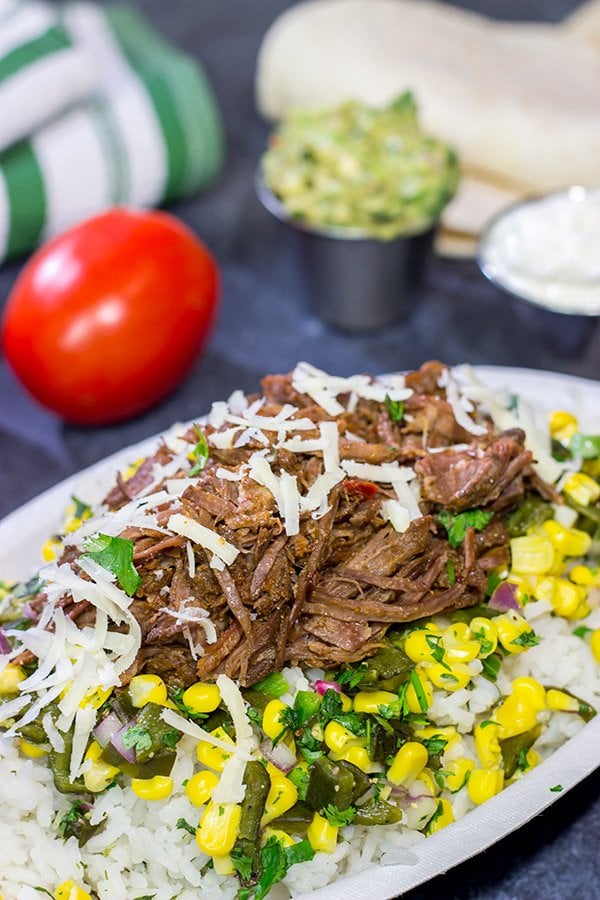 Craving some delicious comfort food?  Then put these Slow Cooker Beef Barbacoa Burrito Bowls on the menu!
