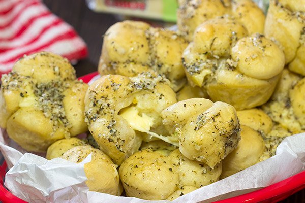 Take a good garlic knot and make it better...by adding cheese!  These Cheesy Muffin Tin Garlic Knots are a fun and tasty snack.  They're sure to become a family favorite!