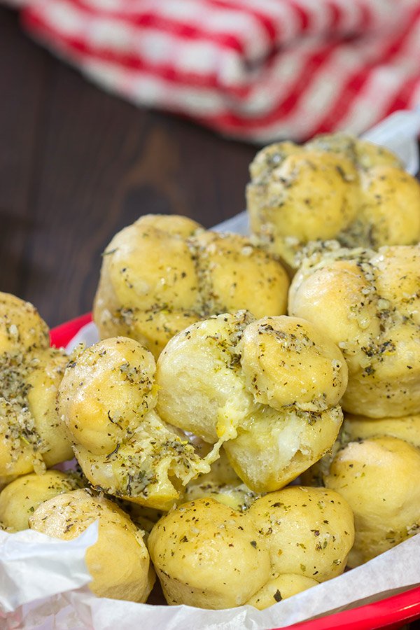 Take a good garlic knot and make it better...by adding cheese!  These Cheesy Muffin Tin Garlic Knots are a fun and tasty snack.  They're sure to become a family favorite!