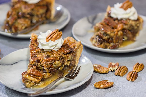 The traditional pecan pie gets a makeover in the form of this Chocolate Bourbon Pecan Pie.  It's a fun and delicious twist on a classic recipe.  Bake one up for dessert today!