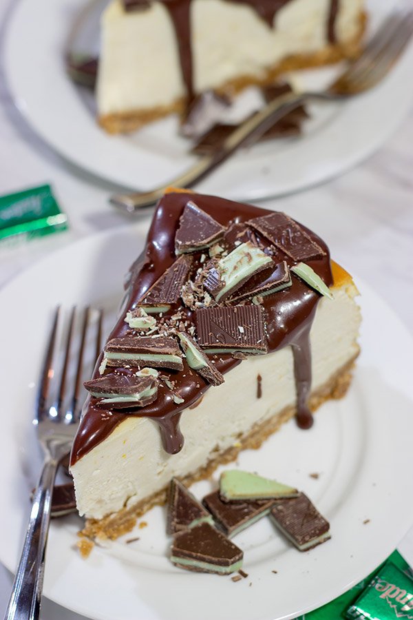 Topped with melted chocolate and chopped Andes mints, this Ricotta Cheesecake with Peppermint Chocolate Sauce is a delicious and fun holiday dessert!