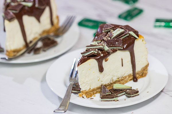 Topped with melted chocolate and chopped Andes mints, this Ricotta Cheesecake with Peppermint Chocolate Sauce is a delicious and fun holiday dessert!