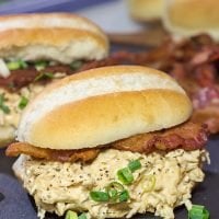 Creamy, shredded chicken topped with crunchy bacon = delicious. These Slow Cooker Crack Chicken Sandwiches are an easy and delicious recipe!