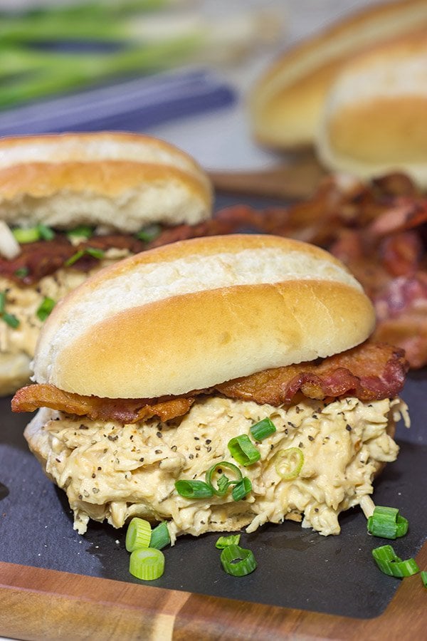 Creamy, shredded chicken topped with crunchy bacon = delicious.  These Slow Cooker Crack Chicken Sandwiches are an easy and delicious recipe!