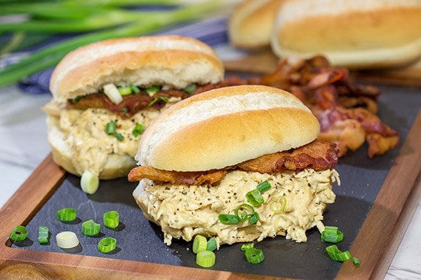 Creamy, shredded chicken topped with crunchy bacon = delicious.  These Slow Cooker Crack Chicken Sandwiches are an easy and delicious recipe!