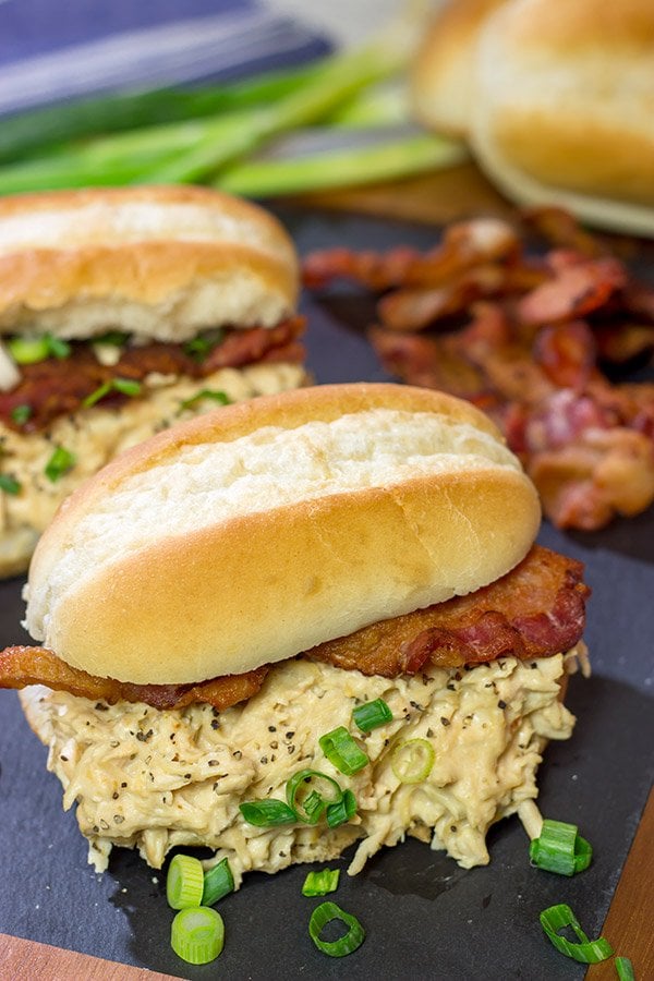 Creamy, shredded chicken topped with crunchy bacon = delicious.  These Slow Cooker Crack Chicken Sandwiches are an easy and delicious recipe!