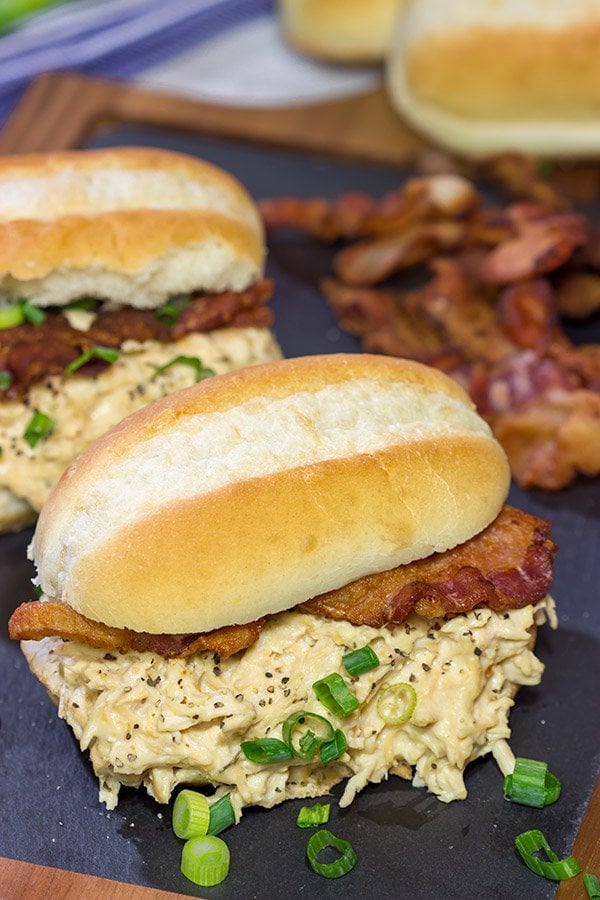 Creamy, shredded chicken topped with crunchy bacon = delicious.  These Slow Cooker Crack Chicken Sandwiches are an easy and delicious recipe!