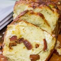Looking for a fun homemade bread? Try adding crispy bacon and melty cheese! This Bacon Cheddar Pull Apart Bread not only smells great, but it tastes even better!