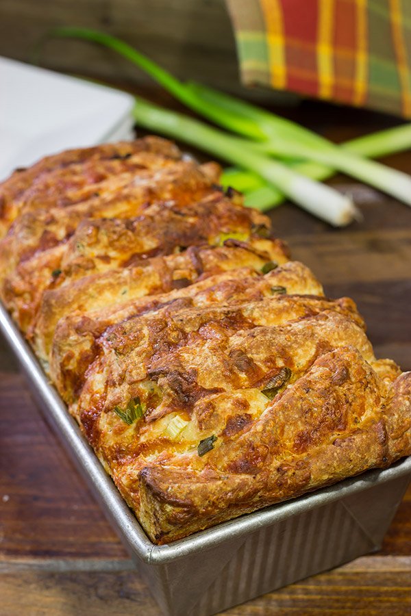 Looking for a fun homemade bread?  Try adding crispy bacon and melty cheese!  This Bacon Cheddar Pull Apart Bread not only smells great, but it tastes even better!
