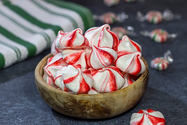 Add a festive touch to the holiday cookie tray with a batch of these Peppermint Meringues!  These light and airy treats are perfect for the holidays!