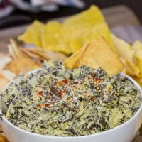 This Slow Cooker Spinach Artichoke Dip is a party favorite! It only takes a few minutes to mix, and then the slow cooker does the rest!