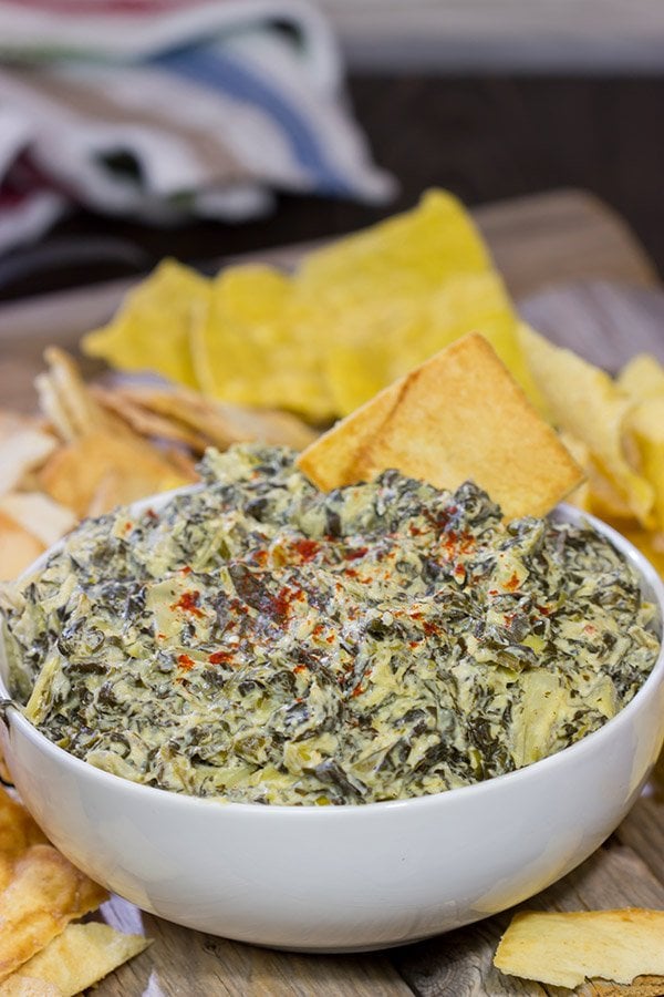 This Slow Cooker Spinach Artichoke Dip is a party favorite!  It only takes a few minutes to mix, and then the slow cooker does the rest!